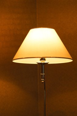 Gece boyunca sıcak ışık sağlayan bir odada bir lamba yakılır..