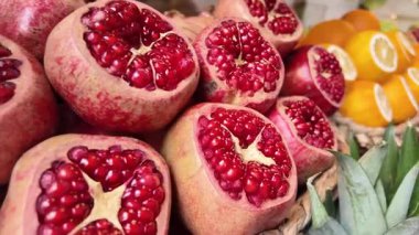 Kesilmiş nar ve portakallar bir pazarda satışta sergilenir.