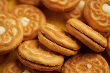 Kurabiyeler bir mutfak ortamında sarı bir yüzeye yerleştirilir..