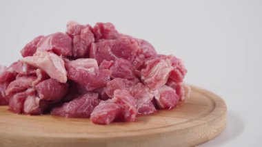 Taze etin nasıl kesildiğini ve tahta bir tahtaya nasıl yerleştirildiğini izleyin..