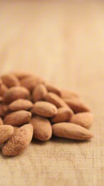 Ahşap bir masada fındıklar yatar. Birbirlerine yakınlar..