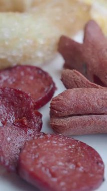 Mutfakta farklı türde sosisleri doğrayıp pişirmek..