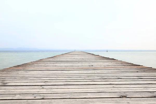 Lake Garda Pier.  The view along a wooden pier from the resort town of Sirmione on the banks of Lake Garda in north east Italy.