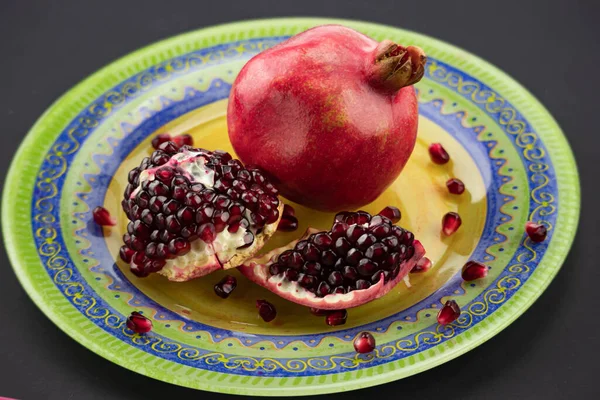 Stock image fresh ripe pomegranate on a yellow background garnet in the section.