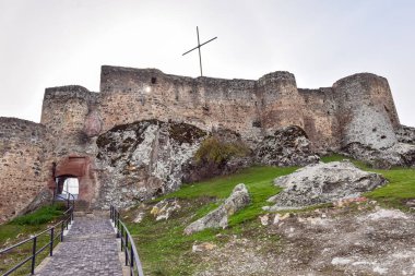 Kveshi fortress with pathway and cross on top. Historical and cultural heritage n Georgia. clipart