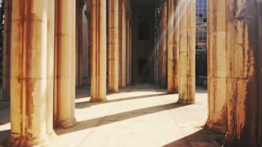 Point of view walk exploring old historical landmark site surrounded by columns background