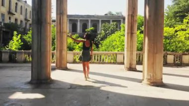 Tracking view caucasian female tourist takes photograph in scenic historical landmark alone enjoy solo travel.