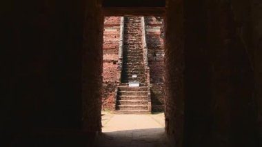 Tayland, Ayutthaya - 15 Mart 2023: Geleneksel Tayland elbiseli kadın antik Buda heykelini ziyaret ediyor. Ayutthaya tarihi parkı. UNESCO Dünya Mirası Alanı