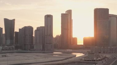 Abu Dabi, BAE - 25 Nisan 2025: hava manzaralı apartman ve boş arazi alanındaki iş kompleksi. Sabah otoyol. Satılık arazi. Kentsel büyüme ve emlak gelişimi BAE ufuk çizgisine karşı