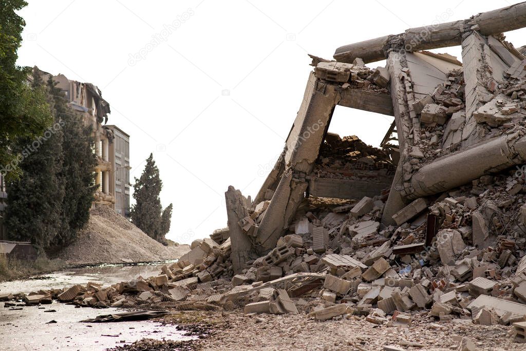 Collapsed concrete industrial building isolated on white. Disaster scene full of debris, dust and damaged house.