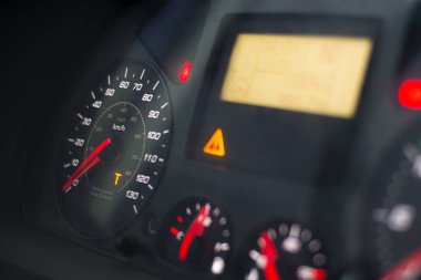 Capital T orange warning lit on speedometer of a heavy truck. Digital tachograph indicates 15 minutes left before the driver must take a brake after 4,5 hours of driving. clipart