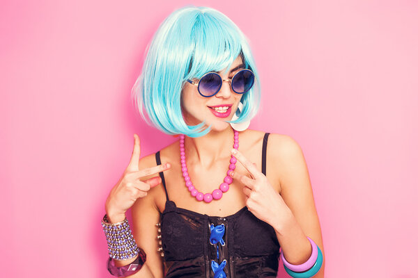 Weird and funny pop girl portrait wearing blue wig
