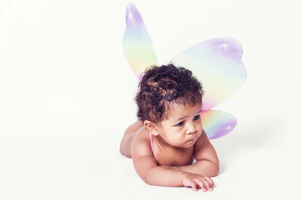 Lovely baby girl wearing colorful fairy wings — Stock Photo, Image