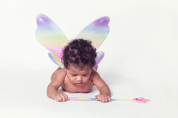 Lovely baby girl wearing fairy wings and holding fairy wand — Stock Photo, Image