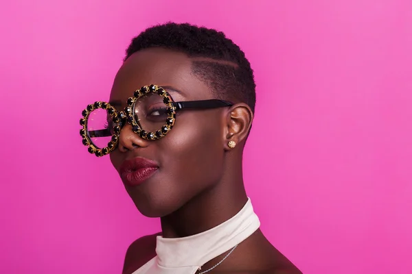Beautiful african girl portrait wearing odd glasses and smiling — Stock Photo, Image