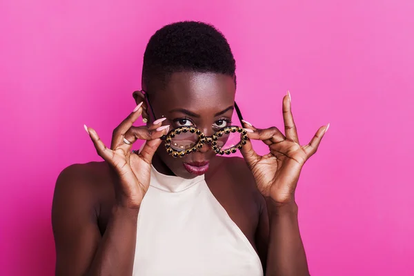 Beautiful sullen african girl portrait wearing funny glasses — Stock Photo, Image