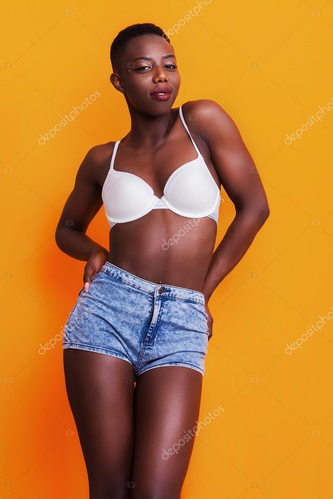 Beautiful and proud african girl wearing jeans shorts and bra