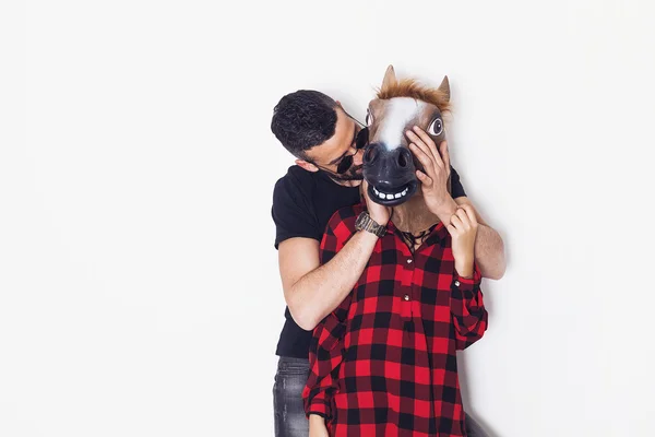 Man playing hide-and-seek with crazy horse head girlfriend — Stock Photo, Image