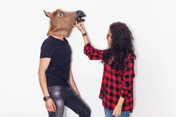 Pretty girl portrait caressing her horse head boyfriend — Stock Photo, Image