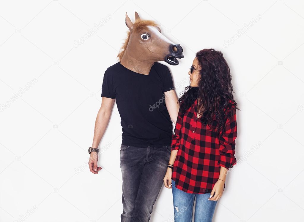 Horse head man and pretty girl looking at each other