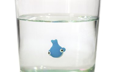 Tiny whale swimming in glass of water clipart