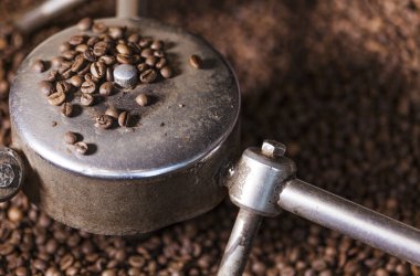 Coffee beans close-up in the coffee roaster clipart