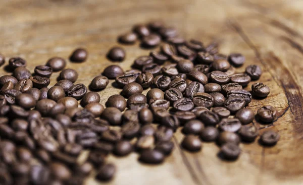 Coffee beans on wood — Stock Photo, Image