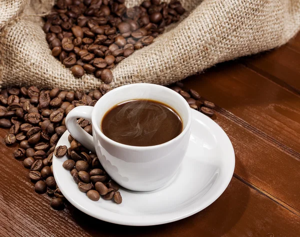 Coffee cup and jute sack full of coffee beans 3 — Stock Photo, Image