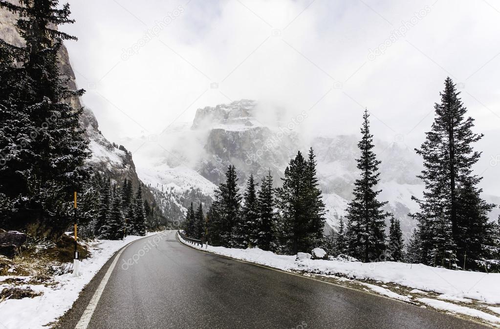 Driving in foggy and rainy winter landscape