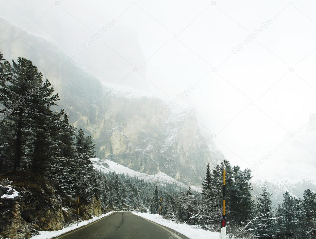 Driving in foggy winter landscape