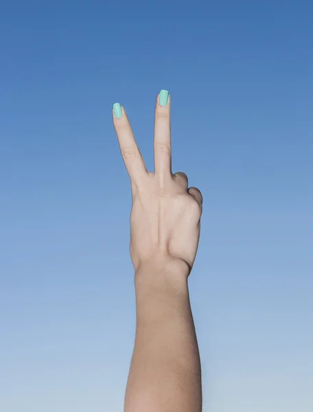 Female beautiful hand up in the sky making victory gesture