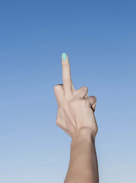 Female hand up in the sky making middle finger gesture — Stock Photo, Image