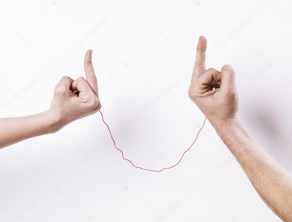 Married couple with red string of fate fighting