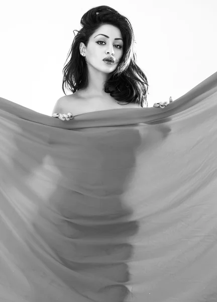 Beautiful naked woman hiding behind cloth black and white — Stock Photo, Image