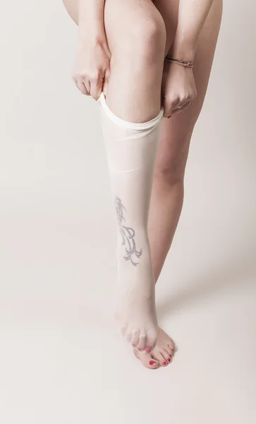 Female legs wearing transparent white stockings — Stock Photo, Image