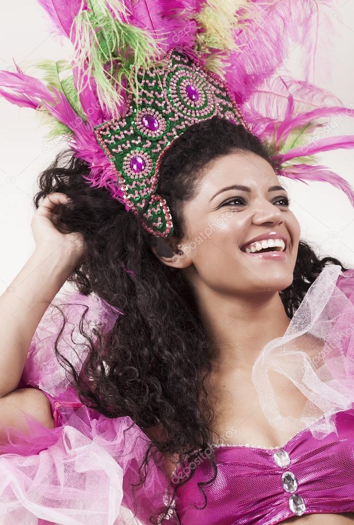Happy and beautiful samba dancer wearing traditional pink costum