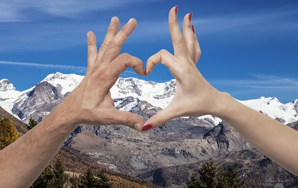 Double exposure of heart gesture and mountains — Stock Photo, Image