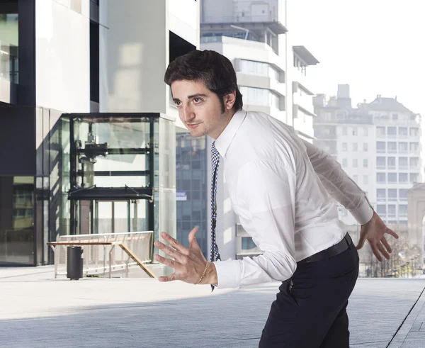 Determined businessman running and urban background — Stock Photo, Image