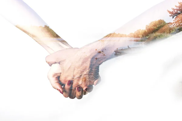 Double exposure of holding hands and autumnal landscape — Stock Photo, Image