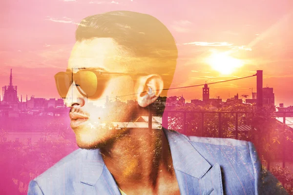 Double exposure of man wearing sunglasses and cityscape — Stock Photo, Image