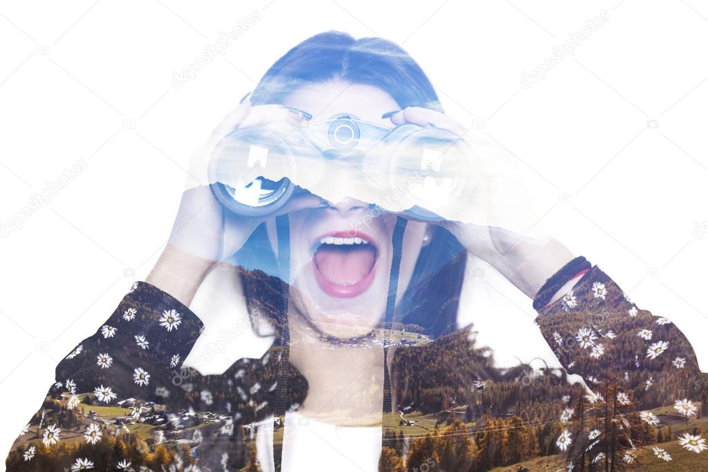 Double exposure of girl looking through binoculars and autumnal 
