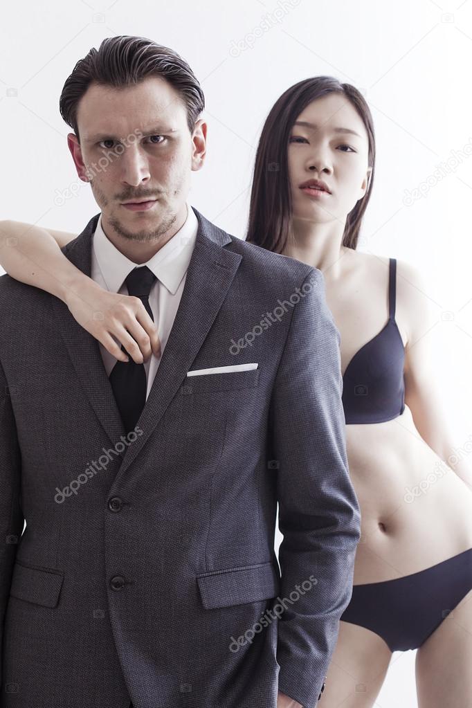 Businessman looking and chinese model wearing underwear and bra Stock Photo patronestaff 69398833