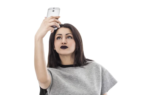 Woman looking upwards and taking a selfie — Stock Photo, Image