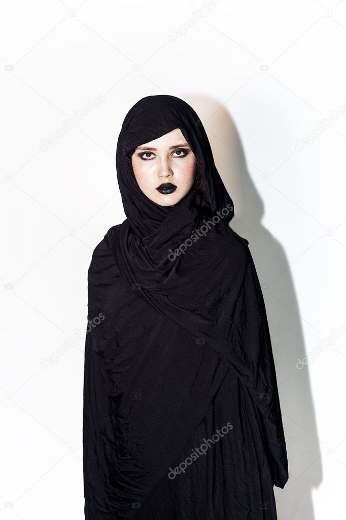 Beautiful model covered by black cloth and wearing black lipstic