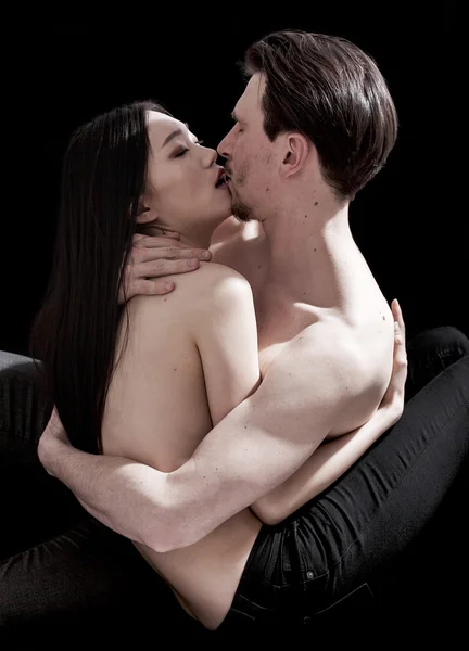 Beautiful bare-chested couple portrait hugging and kissing verti — Stock Photo, Image