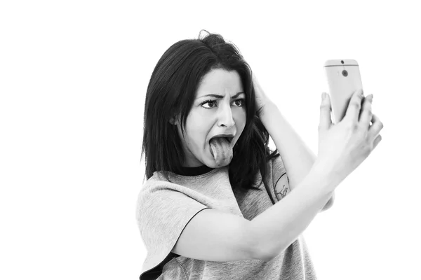 Funny woman making grimace and taking selfie black and white — Stock Photo, Image