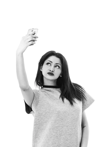 Pretty woman looking upwards and taking selfie black and white — Stock Photo, Image