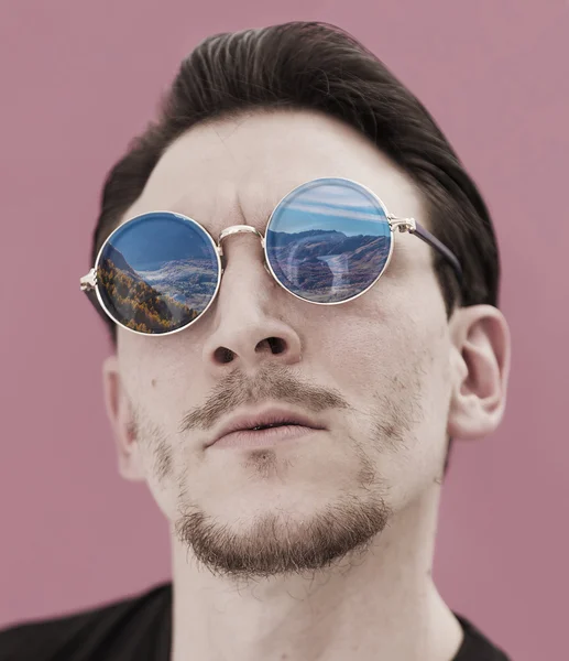 Male portrait wearing sunglasses reflecting landscape — Stock Photo, Image