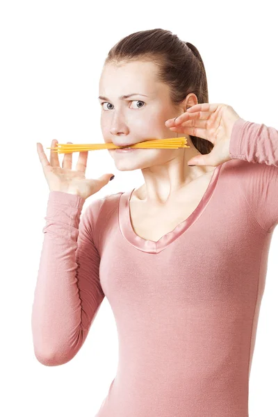 Funny girl biting bunch of spaghetti — Stock Photo, Image