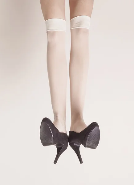 Female legs up in the air wearing heels and posing — Stock Photo, Image